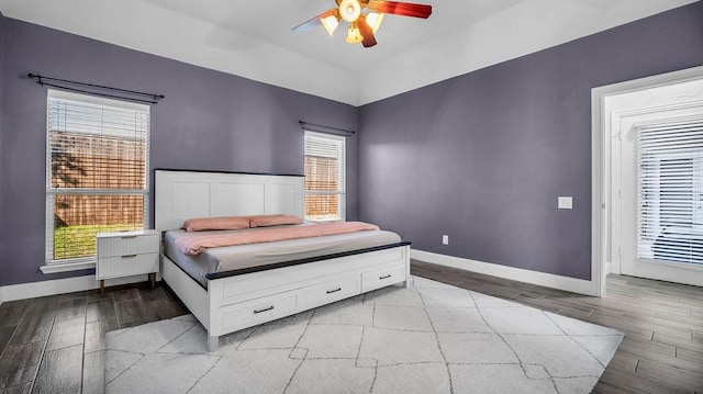 bedroom featuring a ceiling fan, light wood-type flooring, and baseboards