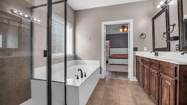 bathroom with tile patterned floors, a stall shower, a sink, double vanity, and a bath