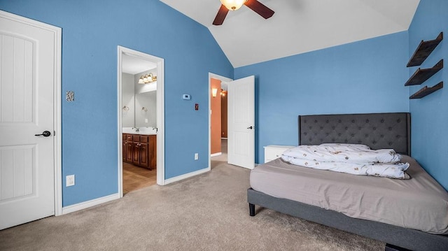 bedroom featuring a sink, connected bathroom, carpet, baseboards, and vaulted ceiling