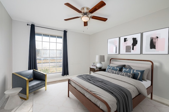 bedroom with a ceiling fan, carpet, and baseboards