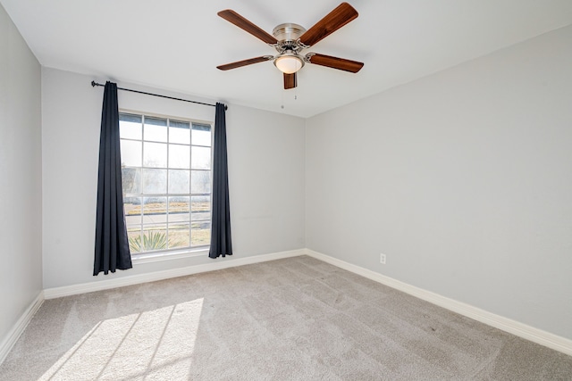 unfurnished room featuring carpet flooring, a ceiling fan, and baseboards