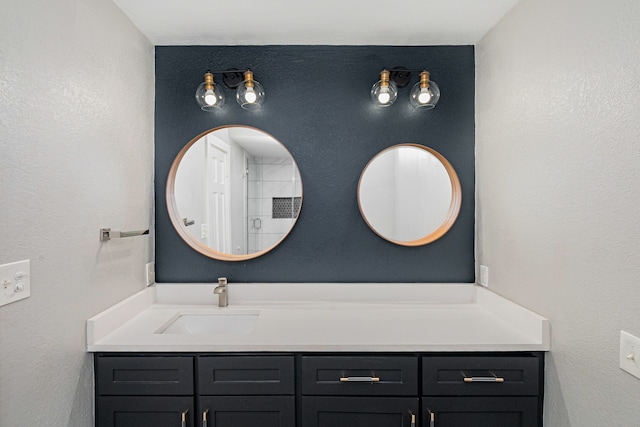 bathroom featuring vanity and a textured wall