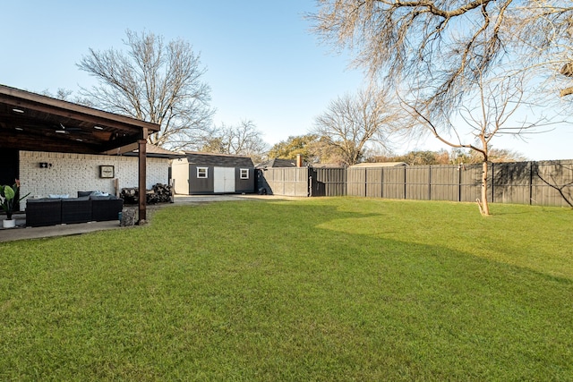 view of yard with outdoor lounge area, an outdoor structure, and a fenced backyard