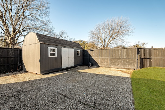 view of shed with a gate and a fenced backyard