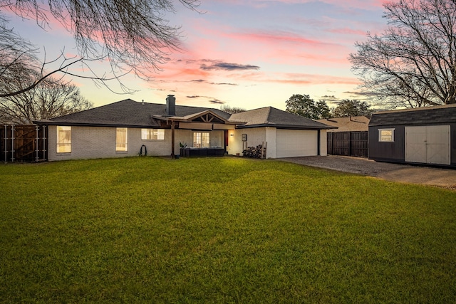 view of front of house with fence, driveway, an attached garage, a chimney, and a lawn