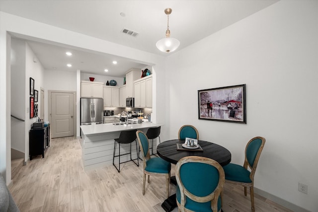 dining room with visible vents, recessed lighting, and light wood-type flooring