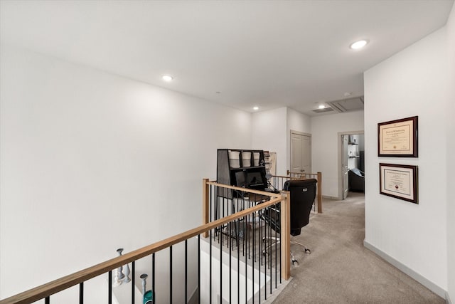 hallway featuring baseboards, attic access, recessed lighting, light carpet, and an upstairs landing