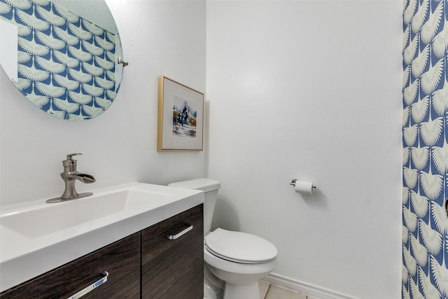 bathroom with tile patterned flooring, toilet, and vanity