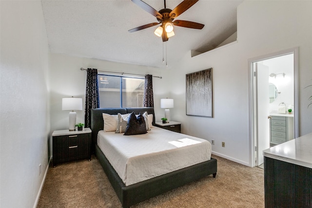 bedroom featuring light colored carpet, ensuite bathroom, baseboards, and vaulted ceiling