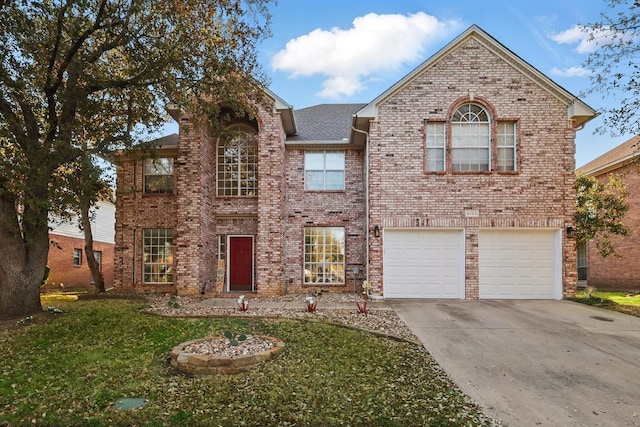 traditional-style house with a front lawn, brick siding, an attached garage, and driveway