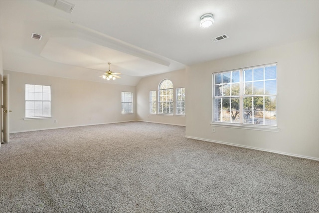 carpeted empty room with visible vents, ceiling fan, and baseboards