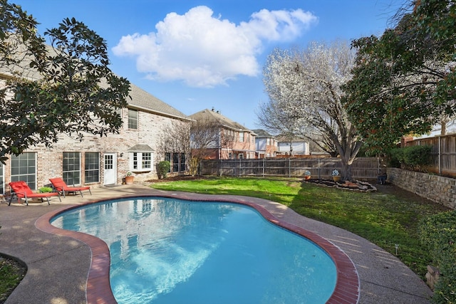 view of pool featuring a yard, a patio, a fenced in pool, and a fenced backyard