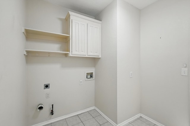 clothes washing area featuring baseboards, washer hookup, hookup for a gas dryer, cabinet space, and hookup for an electric dryer