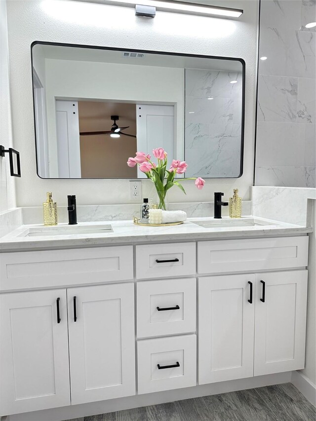 bathroom featuring a sink, ceiling fan, and double vanity