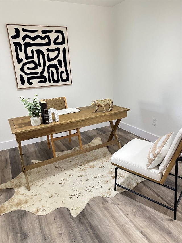 interior space featuring wood finished floors and baseboards