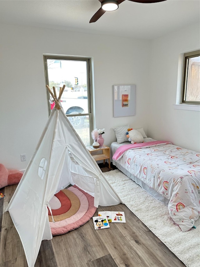 bedroom with ceiling fan and wood finished floors