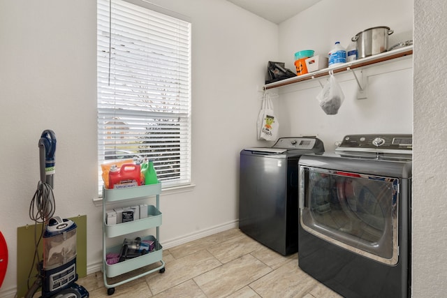 laundry room featuring baseboards, laundry area, and washing machine and clothes dryer