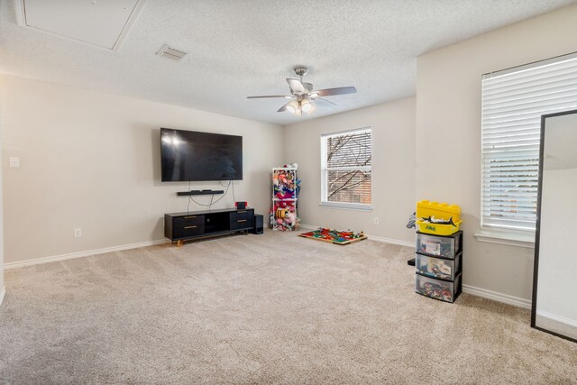 game room with visible vents, a textured ceiling, ceiling fan, and carpet floors