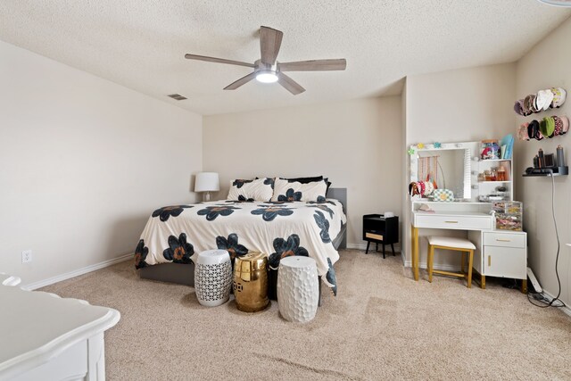 bedroom with visible vents, baseboards, a textured ceiling, and carpet flooring