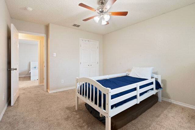 carpeted bedroom with a closet, visible vents, ceiling fan, and baseboards