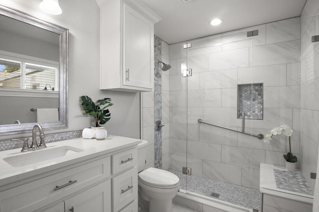 bathroom with recessed lighting, toilet, a stall shower, and vanity