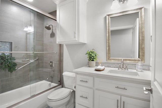 full bathroom featuring toilet, vanity, and bath / shower combo with glass door