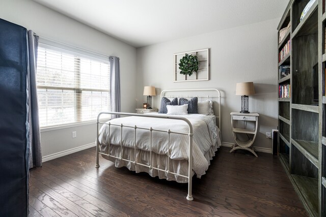 bedroom with wood finished floors and baseboards