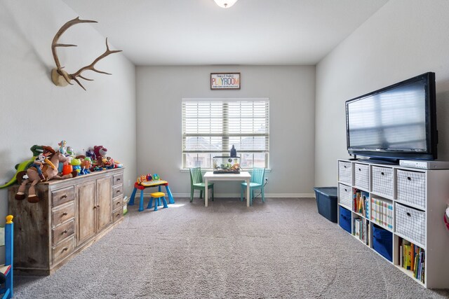 recreation room with carpet flooring and baseboards