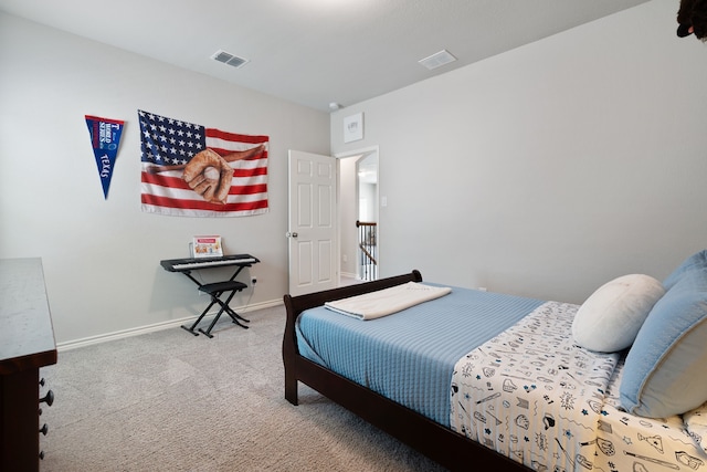 bedroom featuring visible vents, baseboards, and carpet