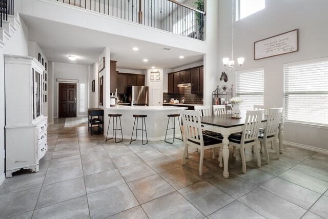 dining space featuring visible vents, a notable chandelier, recessed lighting, light tile patterned flooring, and baseboards