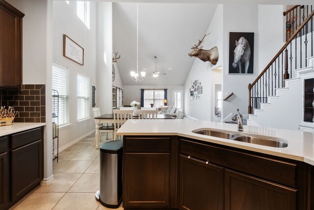 kitchen with light tile patterned floors, open floor plan, plenty of natural light, and a sink