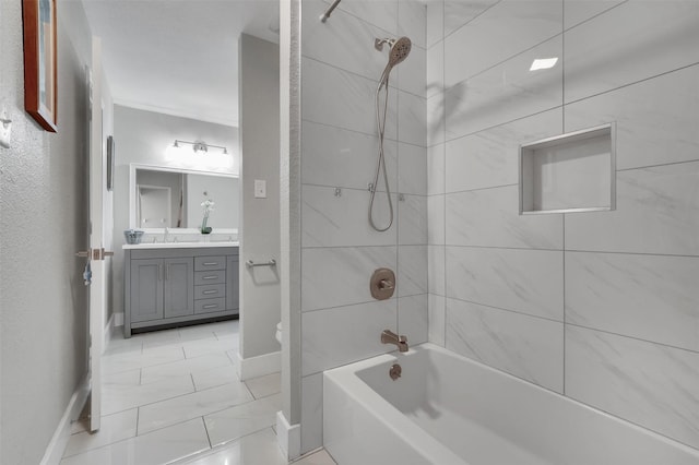 full bathroom with baseboards, vanity, and shower / tub combination