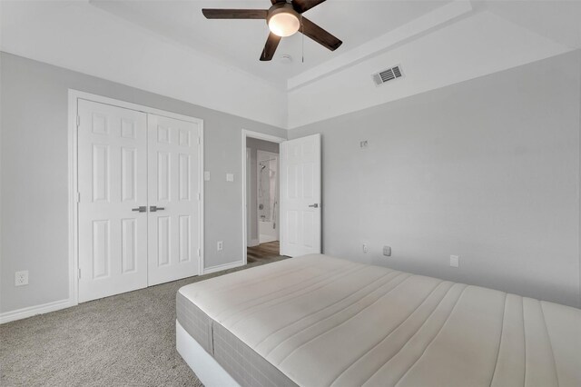carpeted bedroom featuring baseboards, a ceiling fan, visible vents, and a closet