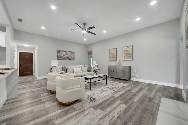 living room featuring recessed lighting, light wood-type flooring, baseboards, and ceiling fan