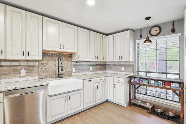 kitchen featuring pendant lighting, a sink, backsplash, white cabinetry, and dishwasher