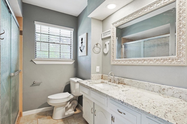 full bathroom featuring toilet, a shower stall, tile patterned flooring, baseboards, and vanity