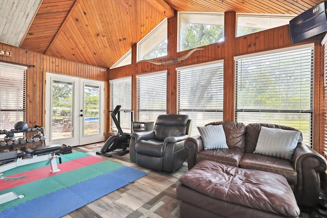 living area with french doors, wood finished floors, wood ceiling, and wood walls