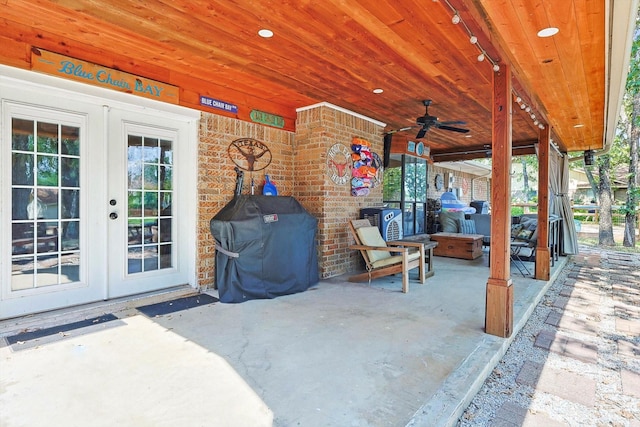 view of patio featuring an outdoor fire pit, area for grilling, french doors, and ceiling fan