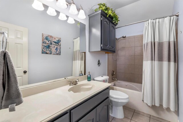 full bathroom featuring tile patterned flooring, toilet, vanity, and shower / tub combo