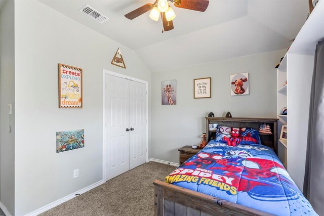 carpeted bedroom featuring a closet, visible vents, baseboards, and lofted ceiling