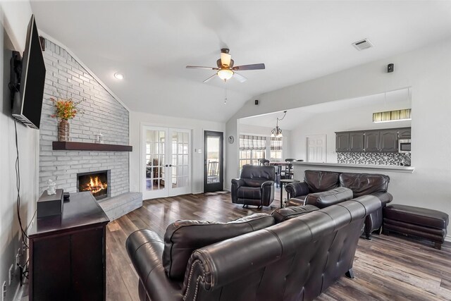 living room featuring vaulted ceiling, wood finished floors, visible vents, and french doors