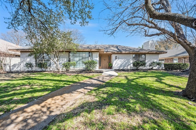 1605 Tampico Dr, Plano, TX 75075 - view of front of home featuring brick siding, a chimney, and a front lawn