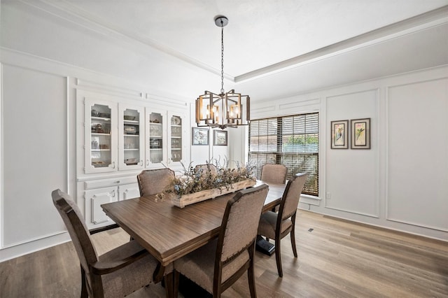 1605 Tampico Dr, Plano, TX 75075 - dining room with a decorative wall, a chandelier, light wood-style flooring, and a tray ceiling