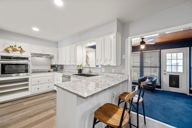 1605 Tampico Dr, Plano, TX 75075 - kitchen with appliances with stainless steel finishes, under cabinet range hood, ceiling fan, recessed lighting, and white cabinetry