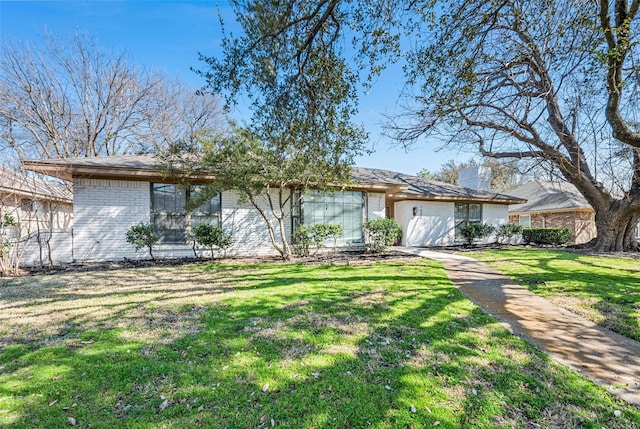 mid-century home featuring a front yard and brick siding