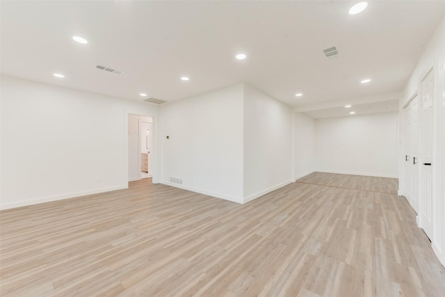 spare room with light wood-style flooring, recessed lighting, and visible vents