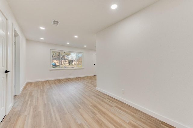 empty room with visible vents, recessed lighting, light wood-type flooring, and baseboards