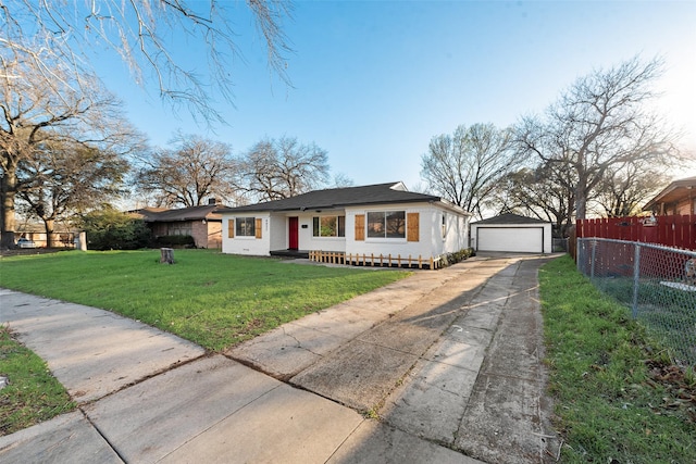 bungalow-style home with a front lawn, a detached garage, fence, an outdoor structure, and brick siding