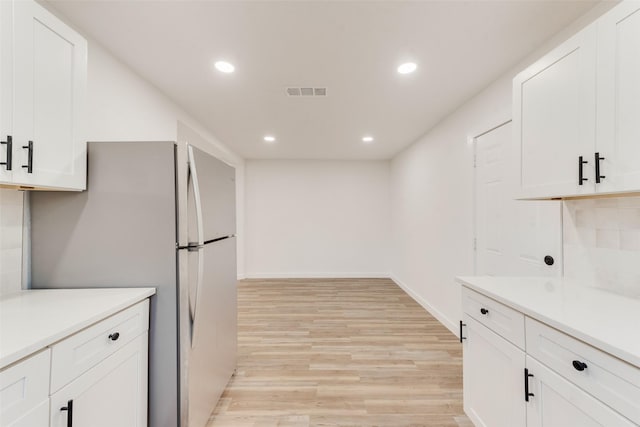 kitchen featuring light wood-type flooring, visible vents, recessed lighting, white cabinets, and light countertops