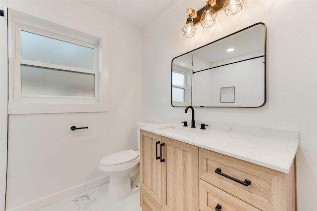 bathroom featuring vanity, toilet, baseboards, and marble finish floor